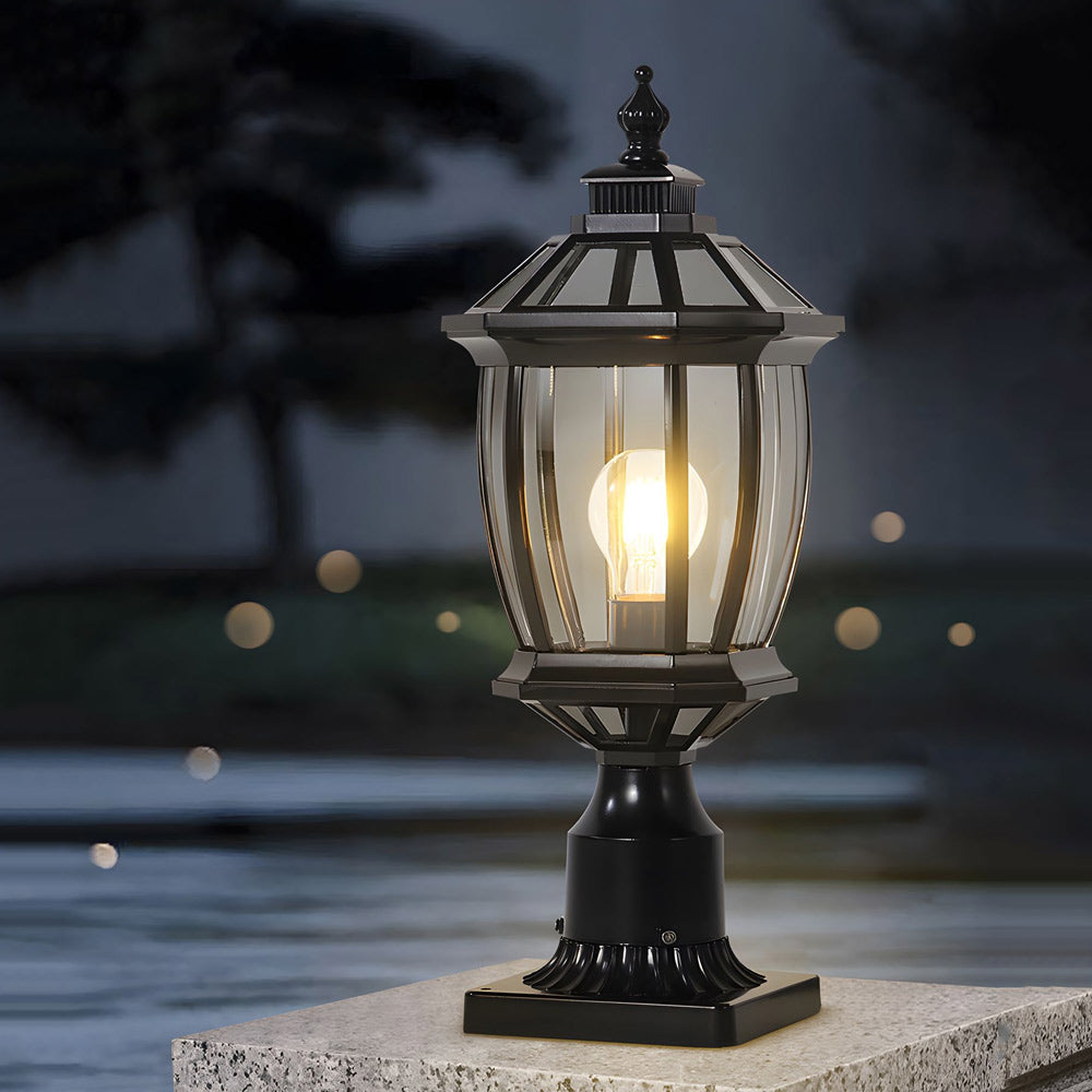 Victorian-inspired pedestal light glowing warmly on outdoor surface with classic hexagonal glass design