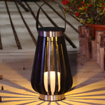 Illuminated decorative lantern on wooden deck creating warm ambient lighting and shadow patterns