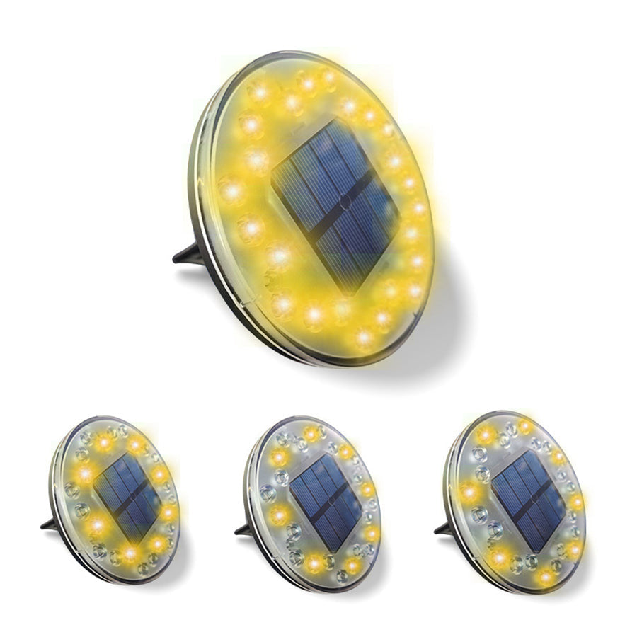 Set of four yellow solar deck lights with integrated solar panels for outdoor pathway illumination